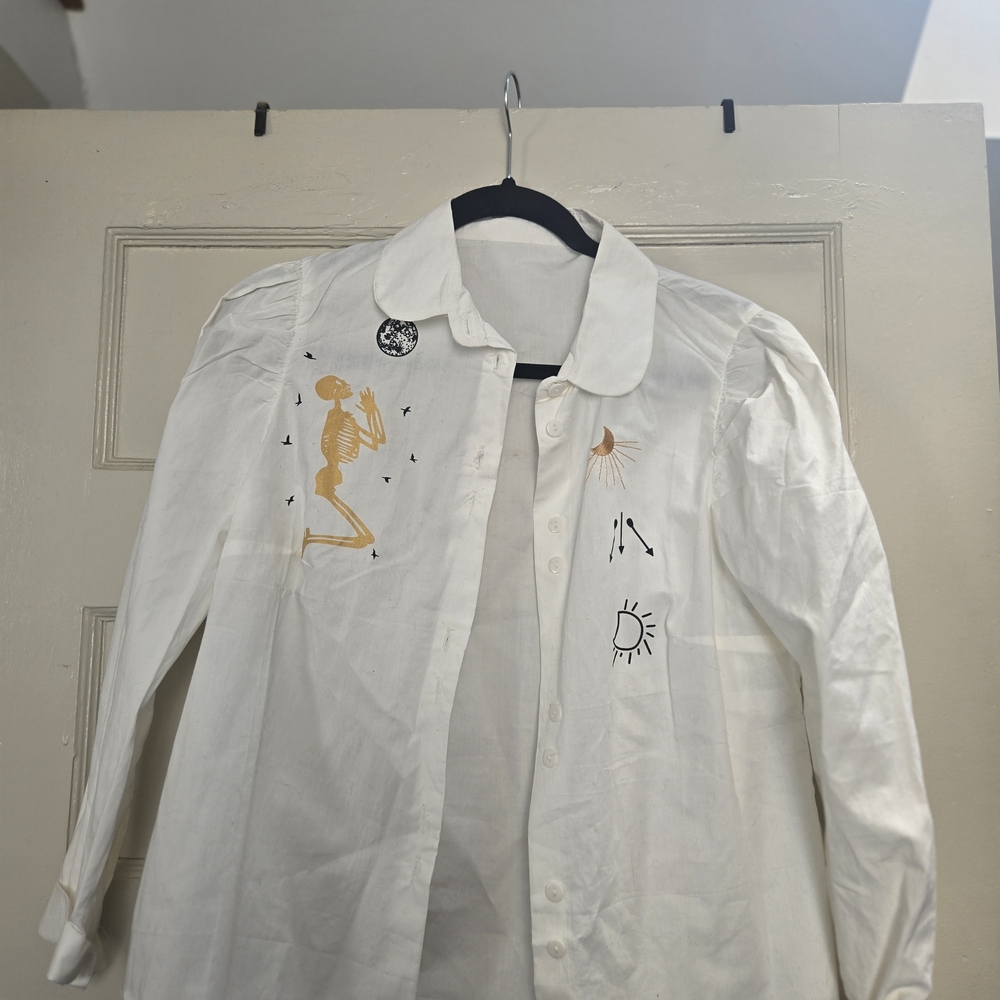 Artistic White Shirt with Skeleton and Sun Designs